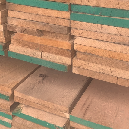 Image of a number of reclaimed wooden planks stacked together